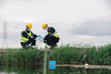 Two Environmental Engineers Take Water Samples at Natural Water Sources Near Farmland Maybe Contaminated by Toxic Waste or Suspicious Pollution Sites