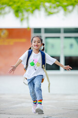 Little kid girl asian with a backpack going to school with fun. which increases the development and enhances the learning skills. Concept Back to school.