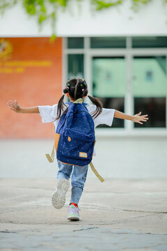 Little kid girl asian with a backpack going to school with fun. which increases the development and enhances the learning skills. Concept Back to school.