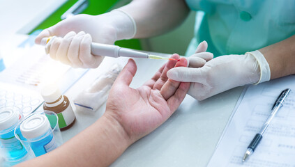 Drop of blood on a finger for medical test to donate blood