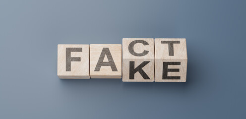 cubes turning message FACT to FAKE. Turned wooden cubes with words Fact vs Fake. Blue background. Business and Fact vs Fake concept - obrazy, fototapety, plakaty