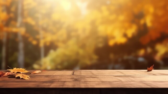 Wooden table space with maple leaves and autumn blur backround