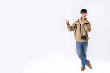 Naklejka premium Full length of traveler handsome asian man pointing out to present something, the smile on his face, his hand gesture and the casual outfit are perfect for the suggestion to copy space.