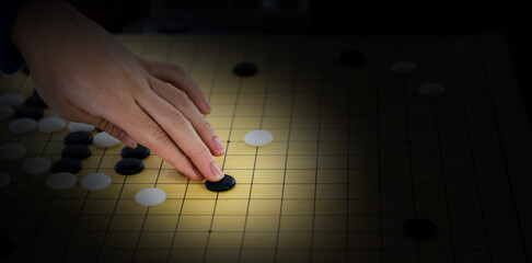 Detail of woman hand playing chinese boardgame