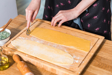 Preparing ravioli with ricotta cheese and spinach. Fresh homemade pasta. Traditional Italian food.