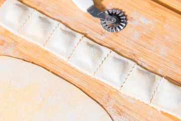 Preparing ravioli with ricotta cheese and spinach. Fresh homemade pasta. Traditional Italian food.