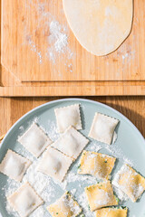 Preparing ravioli with ricotta cheese and spinach. Fresh homemade pasta. Traditional Italian food.