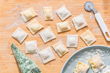 Preparing ravioli with ricotta cheese and spinach. Fresh homemade pasta. Traditional Italian food.