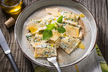 Ravioli with ricotta cheese, parmesan and spinach. Garnished with basil leaves and olive oil. Fresh...