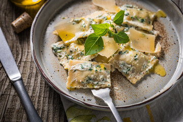 Ravioli with ricotta cheese, parmesan and spinach. Garnished with basil leaves and olive oil. Fresh...