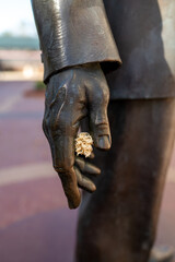 close up of a hand holding a flower