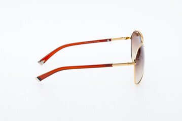Fashion sunglasses red and gold frames on white background.