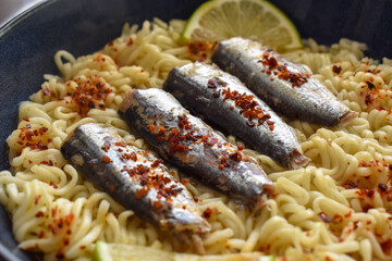 Spicy sardine noodles in a bowl.  Asian food style. 