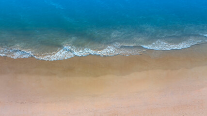 Beach Wave water in the Tropical summer beach with white sand beach background