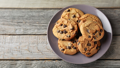 Chocolate chip cookies on plate on grey wooden background