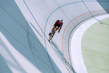 Cyclist training on the cycle track. - obrazy, fototapety, plakaty