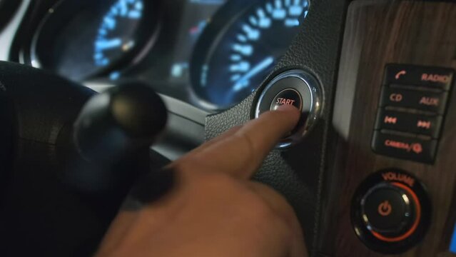 Finger pressing button to off car engine. Finger confidently engages the button, initiating car turns off process. Automotive technology and convenience.