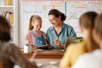 Happy kids and teacher at school