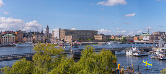 Panorama, the bay Strömmen with ferry piers, the old town Gamla Stan, Government houses and bridges, a sunny summer day in Stockholm