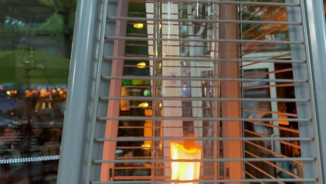 interesting bewitching background fire burning in flask behind bars with chains against the backdrop of a restaurant place for advertising text attracting attention Eternal flame bask warmly when