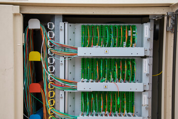 fiber communication inside outdoor neighborhood telecommunication junction box with binding posts and wires for DSL and telephone dial tones