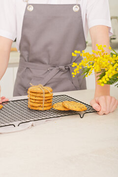 Stack Of Classic Round Bisquits On A Kitchen Rack. Crispy Cookies Made By Teenager Boy In Apron. Teen Guy Showing His Own Pastry Ready To Eat. 