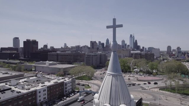 Dynamic Drone Shot Of St. Augustine Roman Catholic Church In Philadelphia, PA - Steeple And Cross In Focus