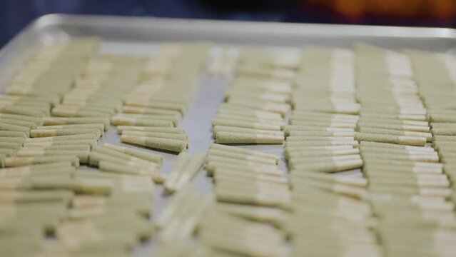 Pre-roll joints kief infused on tray, Cannabis production, Revealing shot