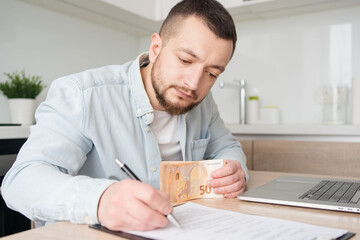 business, finances, accounting and people concept - man with money and calculator filling papers at...