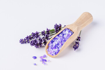 Lavender bath salt with lavender flowers on white background. Lavender herbal sea salt for spa...