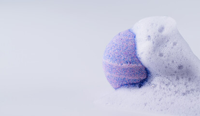 Purple bath bomb with soap on white background. Sea salt in a ball shape for beauty spa treatment...