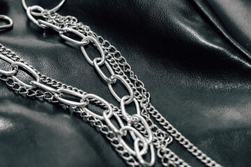 Fototapeta na wymiar Chain on black texture eco soft leather, fashionable jacket.