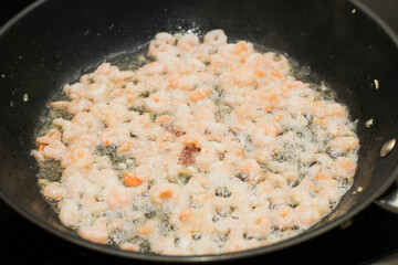 Close-up of peeled, shelled boiled shrimp being fried