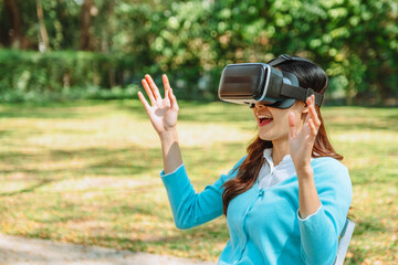 Asian teenage woman using Virtual Reality Glasses having fun with VR simulator.