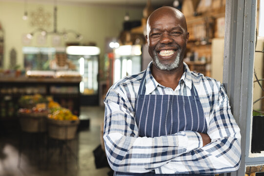 Portrait of happy senior african american shop assistant at health food organic grocery shop