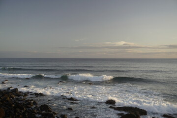 Fototapeta na wymiar Morning over the Atlantic Ocean. Waves in the rays of the rising sun. Surf. Horizon
