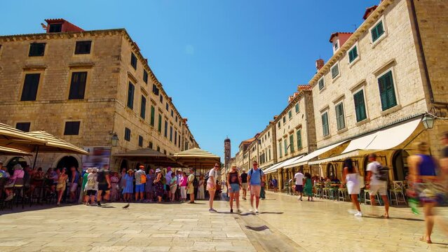 street view timelapse of the old city Dubrovnik, Croatia, crowds of tourists walking through the streets, medieval architecture, bright sunny day, travel
