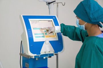 A steadfast surgeon, garbed in sterile surgical attire, is expertly operating an advanced...