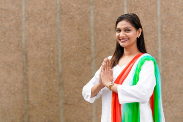 Indian woman giving namaste or welcome gesture.