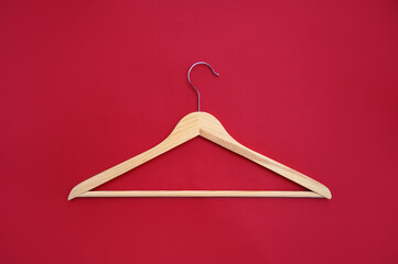 Clothes hanger, Wooden hanger on a red background in a minimalist style.Sale and shopping concept....