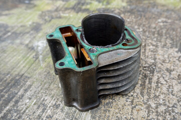 damaged motorcycle piston cylinder block due to incorrect installation of the piston head and late...