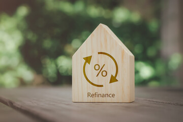 Percentage sign on wooden house with transfer or change symbol. Refinance to reduce the interest of home loan.  Mortgage, loan, repayments, credit limit, interest rate, business and financial concept.