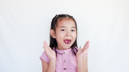 Surprised beautiful little child girl in casual looking to camera on light color background. Human emotions and facial expression.