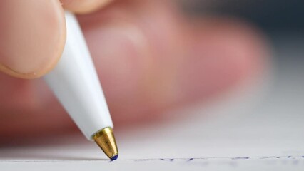 the camera follows the writing pen. pen writes on a sheet of paper, extremely close-up