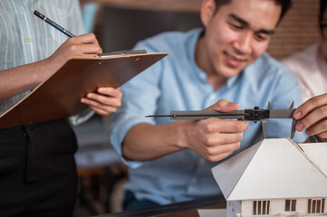 Concepts Architecture and engineer, Engineering, Design and Planning. Engineering hands hold vernier caliper working and checking house model scale between meeting.