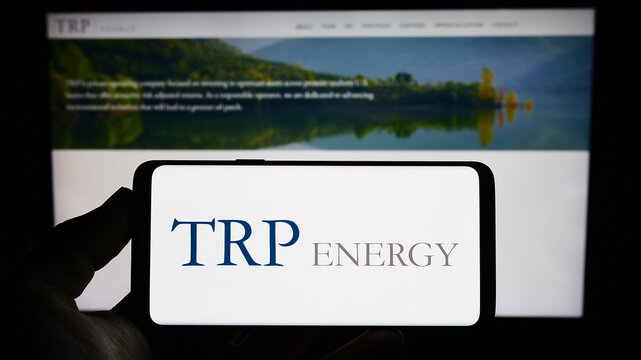 Stuttgart, Germany - 07-08-2023: Person holding mobile phone with logo of American oil and gas company TRP Energy LLC on screen in front of web page. Focus on phone display.