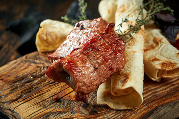 Pork shish kebab on wooden board. Turkish food. Pork grilled on a charcoal barbecue