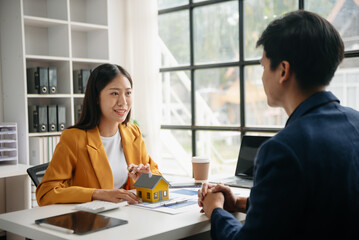  Signing a contract. Client and broker agent, lease agreement, successful deal and  Young business sitting at the desk in office .