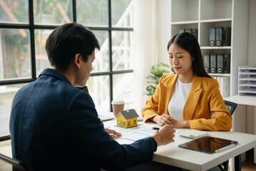  Signing a contract. Client and broker agent, lease agreement, successful deal and  Young business sitting at the desk in office .