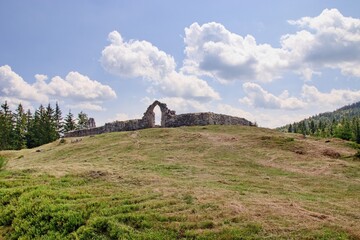 Fototapeta na wymiar The ruins of the former Church of Saint Nicholas in the forest near Horni Slavkov, Czech republic
